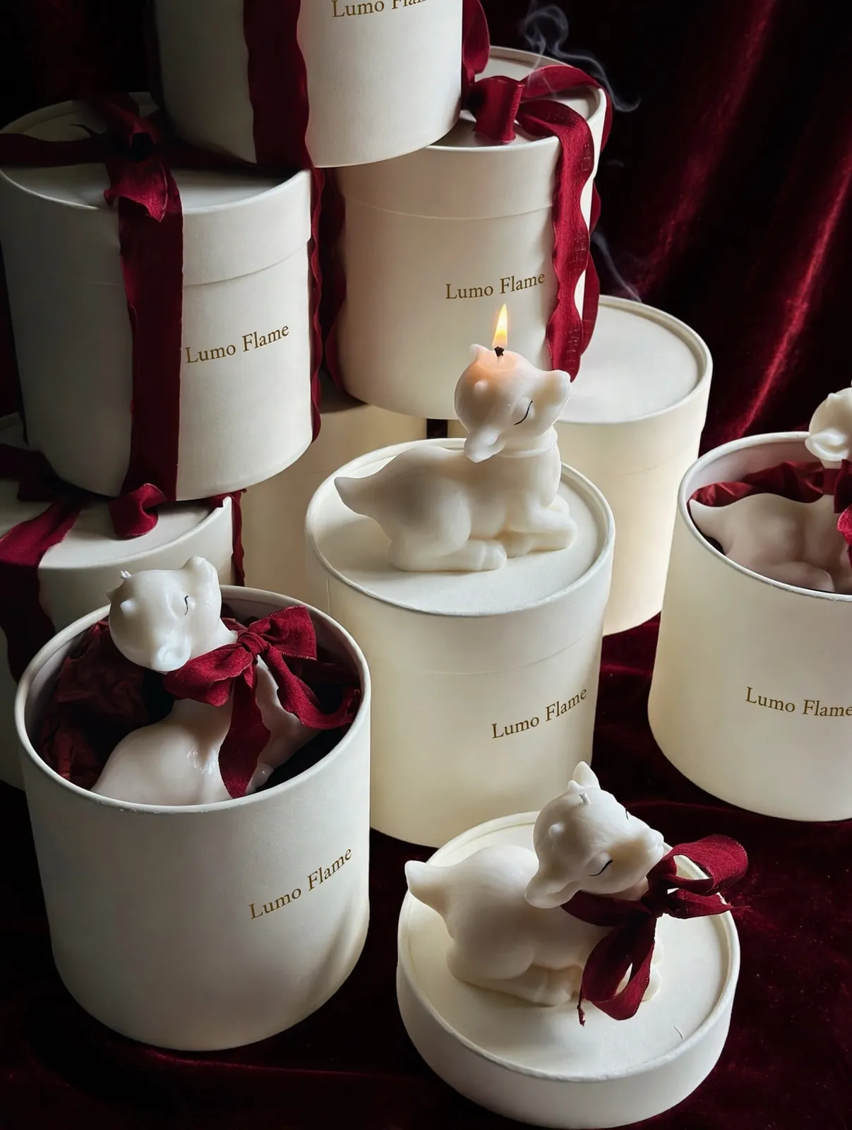 Белые козочки 2027 с бордовыми бантами в фирменной упаковке, центральная свеча горит